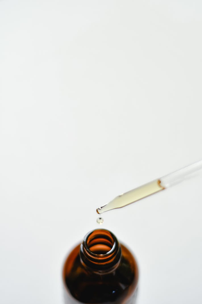 A bottle of lubricating eye drops on a clean surface.